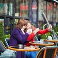 Two girls in Parisian street cafe Royalty Free Stock Photo