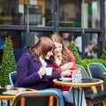 Two girls in Parisian street cafe Royalty Free Stock Photo