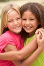 Two Girls In Park Giving Each Other Hug Royalty Free Stock Photo