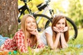 Two girls on a picnic with bikes Royalty Free Stock Photo