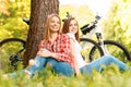 Two girls on a picnic with bikes Royalty Free Stock Photo