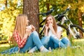 Two girls on a picnic with bikes Royalty Free Stock Photo