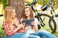 Two girls on a picnic with bikes Royalty Free Stock Photo