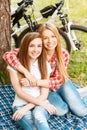 Two girls on a picnic with bikes Royalty Free Stock Photo