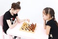 Two girls play chess. White bishop move.