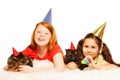 Two girls play party game with their cats Royalty Free Stock Photo