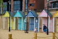 Two girls play in the sand at the man-made Seaside with sand beach, deckchairs and colourful beach huts at Newcastle Quayside
