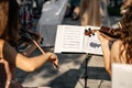 Two girls play violins, read from notes Royalty Free Stock Photo