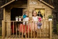 Two girls play with watering can in a tree house