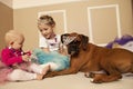 Two girls playing princess dress up with a dog Royalty Free Stock Photo