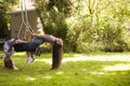 Two Girls Playing Together On Tire Swing In Garden Royalty Free Stock Photo