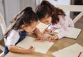 Two girls playing together. two girls completing their homework together. Royalty Free Stock Photo