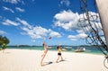 Two girls playing volleyball on white beach Royalty Free Stock Photo