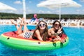 Two sexy young girls playing with water in the pool mattresses watermelon Royalty Free Stock Photo