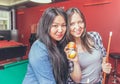 Two girls portrait in a biliard room.