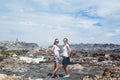 Two girls posing in front of garbage dump