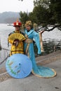 Two girls posing in traditional Chinese costumes on the shores of West Lake in Hangzhou, China