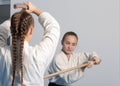 Two girls practice sword on Aikido training on