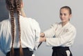 Two girls practice sword on Aikido training