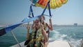 Two girls prepare for take off from boat at parasailing Royalty Free Stock Photo