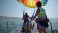 Two girls prepare for take off from boat at parasailing at Beach in Durres