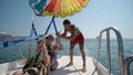 Two girls prepare for take off from boat at parasailing at Beach