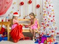 Two girls pulled out a bag of Christmas gifts Santa Claus Royalty Free Stock Photo