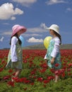 Two girls in a red field Royalty Free Stock Photo