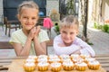 Two girls rejoice freshly baked cupcakes Royalty Free Stock Photo