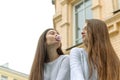 Two girls rest and inflate bubbles of chewing gum Royalty Free Stock Photo