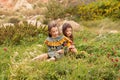 Two girls in retro vintage dresses picking flowers on a meadow field Royalty Free Stock Photo