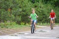 Two girls ride a bike on a rainy warm day Royalty Free Stock Photo