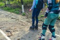 Two girls ride on rollers on a very bad road