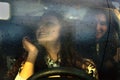 Two girls riding in the car in the rain Royalty Free Stock Photo