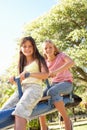 Two Girls Riding On See Saw In Playground Royalty Free Stock Photo