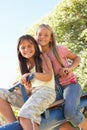 Two Girls Riding On See Saw In Playground Royalty Free Stock Photo