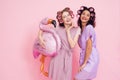 Two girls with hair curlers and pink flamingo baloon. They are celebrating women`s day March 8. Royalty Free Stock Photo