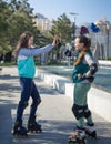 Two girls rollers meet each other in the park