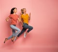 Two girls run fast. Concept of energy and vitality. Pink background