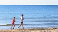 Two girls running on the beach