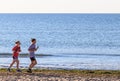 Two girls running on the beach