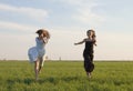 Two girls running on the field 2 Royalty Free Stock Photo