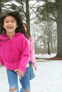 Two girls running through the snow Royalty Free Stock Photo