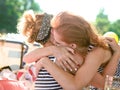 Two girls sea striped shirts hug outside