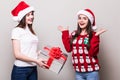 Two girls share Christmas gift box