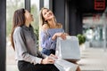 Two girls with shopping sitting on a bench in the Mall Royalty Free Stock Photo