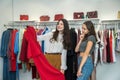 Two girls shopping in the store. Girlfriends choose the best modern clothes in mall Royalty Free Stock Photo