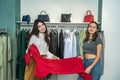 Two girls shopping in the store. Girlfriends choose the best modern clothes in mall Royalty Free Stock Photo