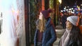 Two girls on a shopping trip in New York walk along shop windows - NEW YORK, USA - DECEMBER 4, 2018