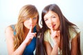 Two girls shushing Royalty Free Stock Photo